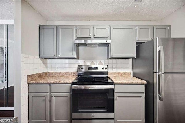 5555 Mountain Springs Cir, Stone Mountain, GA 30088 - kitchen with appliances with stainless steel finishes, under cabinet range hood, gray cabinetry, and a textured ceiling