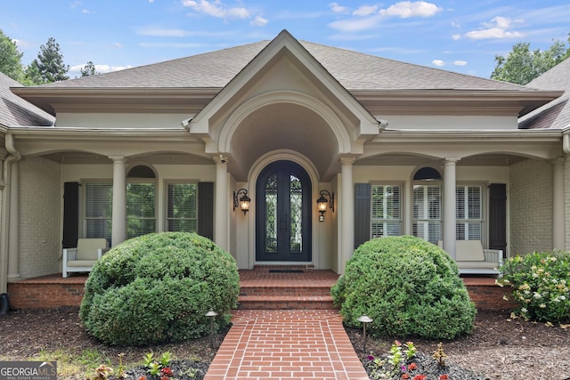 10630 N Edgewater Pl, Johns Creek, GA 30097 - property entrance featuring brick siding, roof with shingles, and french doors