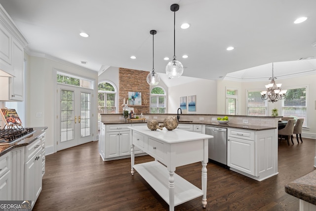 10630 N Edgewater Pl, Johns Creek, GA 30097 - kitchen featuring appliances with stainless steel finishes, a center island, ornamental molding, healthy amount of natural light, and a chandelier