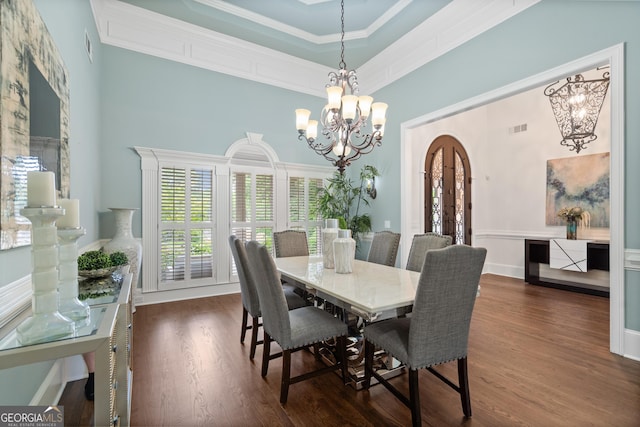 10630 N Edgewater Pl, Johns Creek, GA 30097 - dining space with arched walkways, a chandelier, wood finished floors, ornamental molding, and a high ceiling