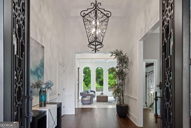 10630 N Edgewater Pl, Johns Creek, GA 30097 - foyer with a chandelier, crown molding, dark wood-type flooring, a towering ceiling, and a decorative wall