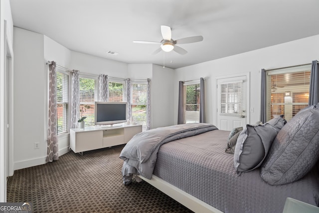 10630 N Edgewater Pl, Johns Creek, GA 30097 - bedroom with dark carpet, baseboards, and a ceiling fan