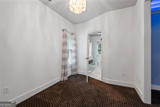 10630 N Edgewater Pl, Johns Creek, GA 30097 - unfurnished bedroom with a chandelier, carpet, baseboards, and connected bathroom