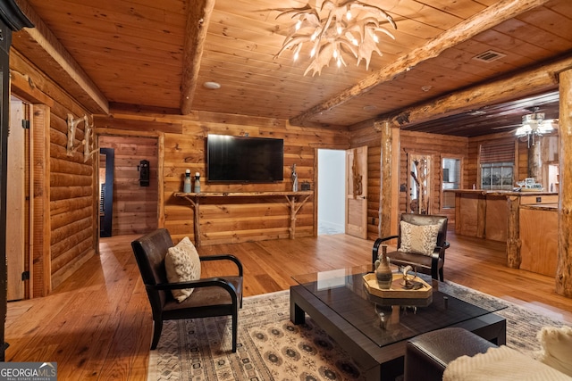 10630 N Edgewater Pl, Johns Creek, GA 30097 - living room with rustic walls, wooden ceiling with exposed beams, wood-type flooring, and a chandelier