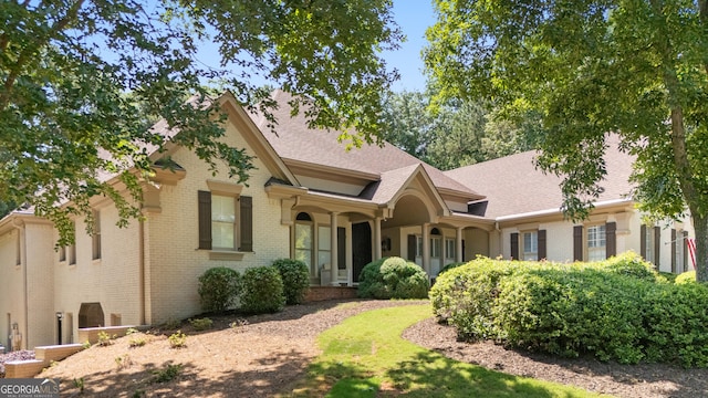 10630 N Edgewater Pl, Johns Creek, GA 30097 - view of front facade featuring brick siding and roof with shingles