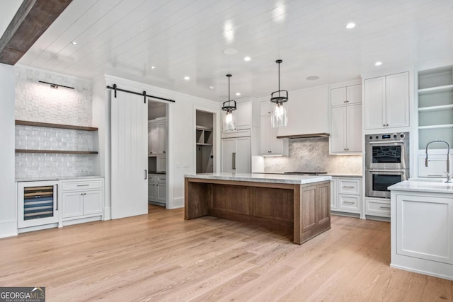 1111 Longview Commons, Greensboro, GA 30642 - kitchen featuring stainless steel double oven, paneled refrigerator, a barn door, wine cooler, and light wood finished floors