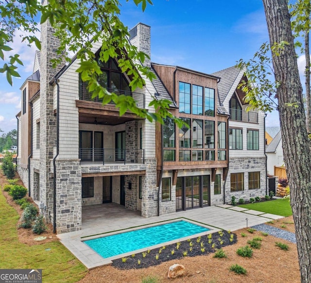 1111 Longview Commons, Greensboro, GA 30642 - back of property featuring a balcony, stone siding, a patio, a chimney, and an outdoor pool