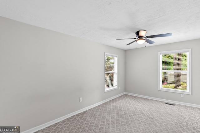 160 Birch Rd, Covington, GA 30014 - carpeted spare room with ceiling fan, baseboards, healthy amount of natural light, and a textured ceiling