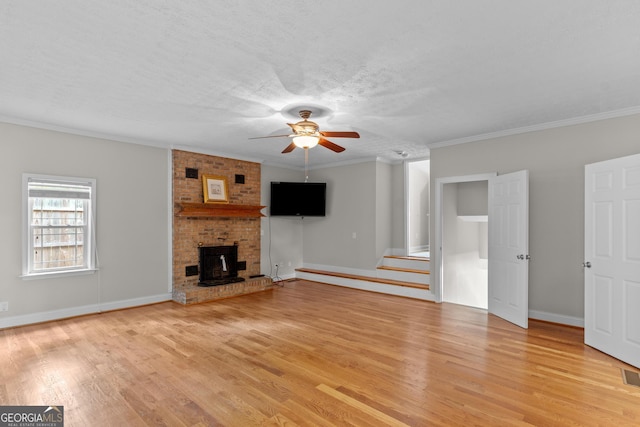 160 Birch Rd, Covington, GA 30014 - unfurnished living room with a ceiling fan, light wood-type flooring, baseboards, crown molding, and a textured ceiling