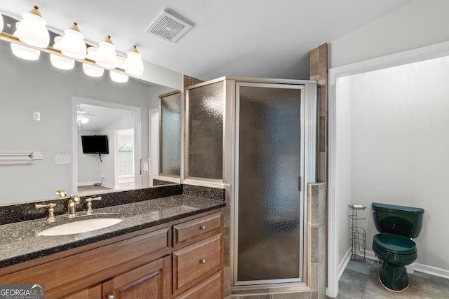 160 Birch Rd, Covington, GA 30014 - bathroom with a shower stall, vanity, a ceiling fan, toilet, and baseboards