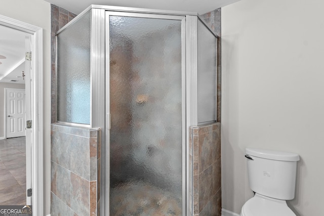160 Birch Rd, Covington, GA 30014 - bathroom with a shower stall, toilet, and baseboards