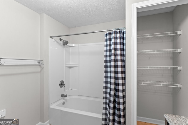 160 Birch Rd, Covington, GA 30014 - bathroom with baseboards, shower / bathtub combination with curtain, and a textured ceiling