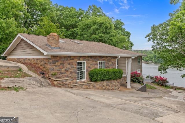 160 Birch Rd, Covington, GA 30014 - view of home's exterior featuring stone siding, a chimney, a shingled roof, and a patio