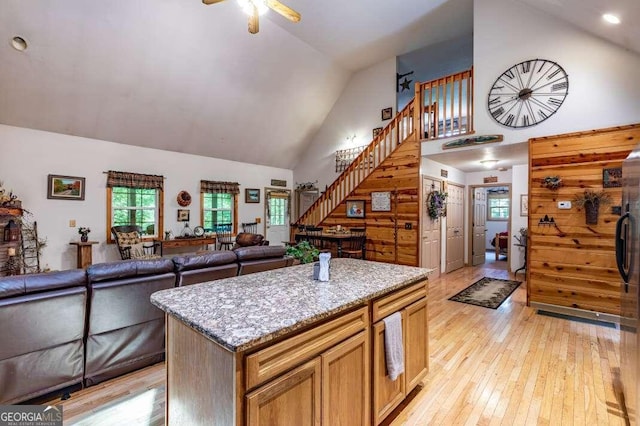 284 Summit Way Unit 19, Blairsville, GA 30512 - kitchen featuring high vaulted ceiling, light wood-style floors, a ceiling fan, light stone counters, and open floor plan