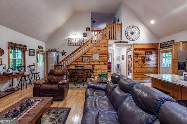 284 Summit Way Unit 19, Blairsville, GA 30512 - living area with high vaulted ceiling, stairs, light wood-style floors, and wood walls