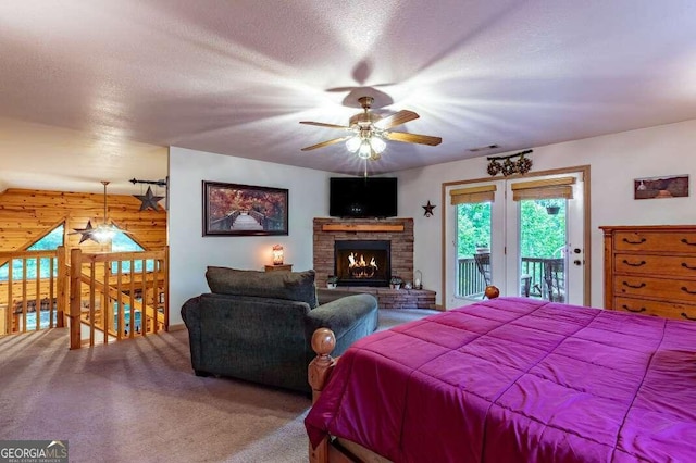 284 Summit Way Unit 19, Blairsville, GA 30512 - carpeted bedroom with access to outside, wooden walls, and a stone fireplace