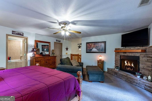 284 Summit Way Unit 19, Blairsville, GA 30512 - carpeted bedroom featuring a fireplace, ensuite bathroom, and a ceiling fan