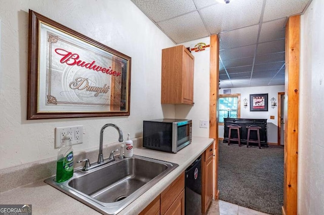 284 Summit Way Unit 19, Blairsville, GA 30512 - kitchen with stainless steel microwave, dishwashing machine, a paneled ceiling, light countertops, and light carpet
