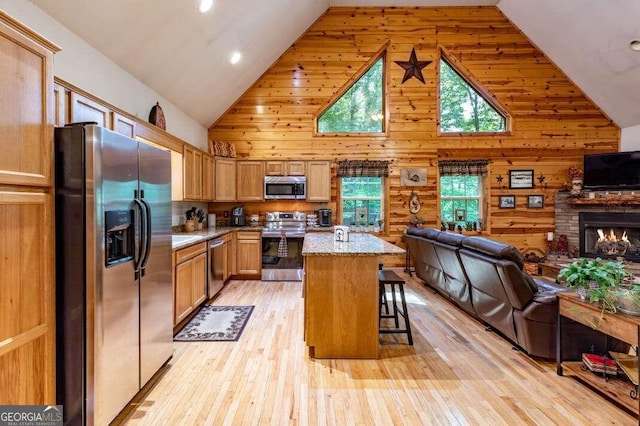 284 Summit Way Unit 19, Blairsville, GA 30512 - kitchen featuring appliances with stainless steel finishes, open floor plan, high vaulted ceiling, healthy amount of natural light, and light wood-style floors