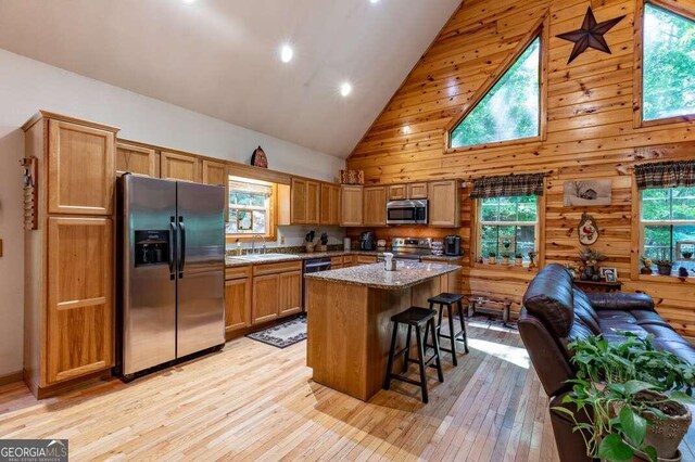 284 Summit Way Unit 19, Blairsville, GA 30512 - kitchen featuring stainless steel appliances, high vaulted ceiling, light wood-type flooring, a kitchen island, and a breakfast bar