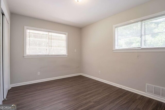 2311 Cherry Blossom Dr SW, Atlanta, GA 30331 - unfurnished bedroom featuring dark wood finished floors, a closet, and baseboards