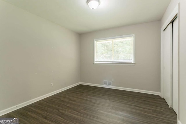 2311 Cherry Blossom Dr SW, Atlanta, GA 30331 - unfurnished bedroom with baseboards and dark wood-style flooring