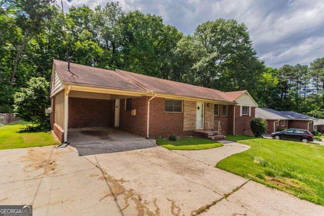 2311 Cherry Blossom Dr SW, Atlanta, GA 30331 - ranch-style house featuring concrete driveway, brick siding, a front yard, and an attached carport