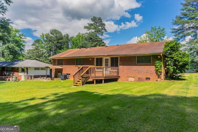 2311 Cherry Blossom Dr SW, Atlanta, GA 30331 - back of house featuring a deck, brick siding, and a yard
