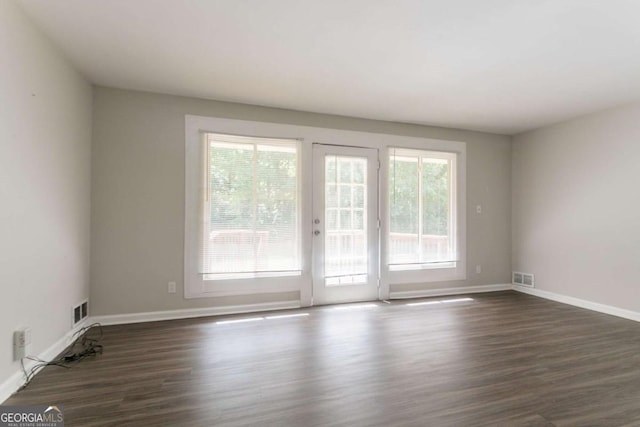 2311 Cherry Blossom Dr SW, Atlanta, GA 30331 - empty room featuring plenty of natural light, dark wood finished floors, and baseboards
