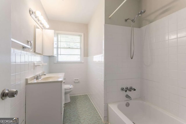 2311 Cherry Blossom Dr SW, Atlanta, GA 30331 - bathroom with tile walls, toilet,  shower combination, vanity, and wainscoting