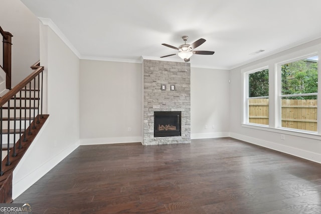 1158 Welch St SW, Atlanta, GA 30310 - unfurnished living room with a ceiling fan, dark wood-type flooring, ornamental molding, stairway, and a stone fireplace