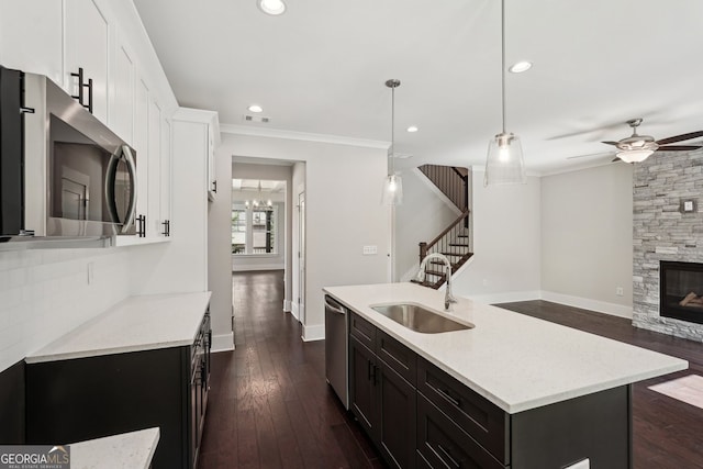 1158 Welch St SW, Atlanta, GA 30310 - kitchen featuring stainless steel appliances, ceiling fan, white cabinets, crown molding, and dark wood finished floors