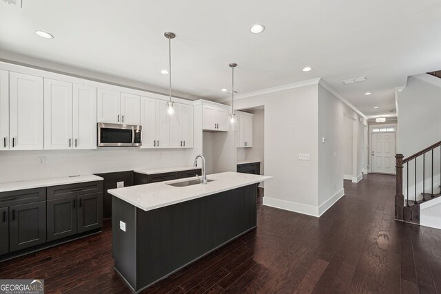 1158 Welch St SW, Atlanta, GA 30310 - kitchen with stainless steel microwave, white cabinets, recessed lighting, a kitchen island with sink, and pendant lighting