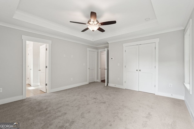 1158 Welch St SW, Atlanta, GA 30310 - unfurnished bedroom featuring a tray ceiling, light colored carpet, ornamental molding, a ceiling fan, and ensuite bathroom