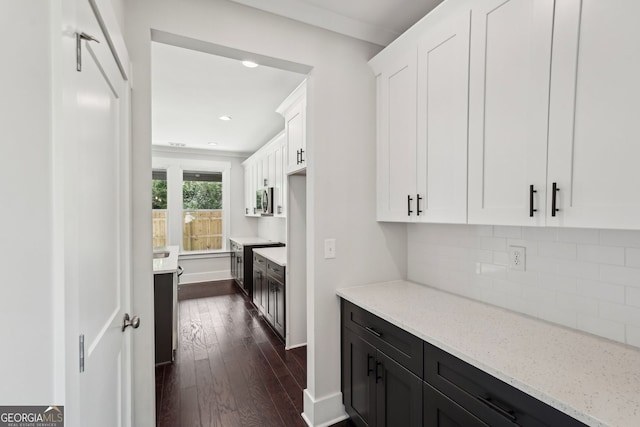 1158 Welch St SW, Atlanta, GA 30310 - kitchen with dark wood finished floors, white cabinetry, light stone countertops, dark cabinetry, and tasteful backsplash