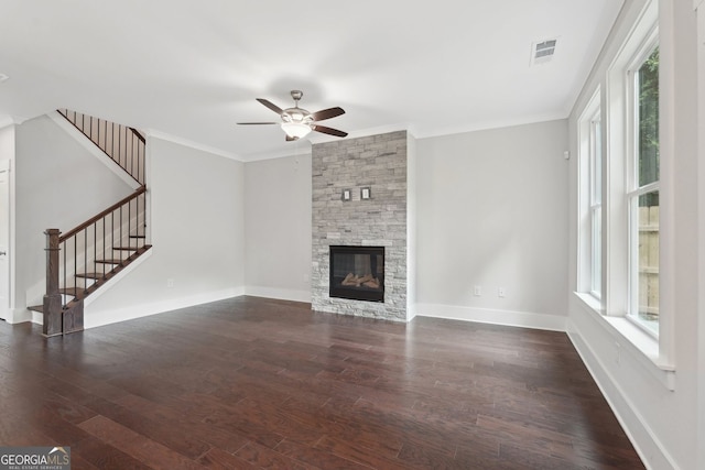 1158 Welch St SW, Atlanta, GA 30310 - unfurnished living room featuring a ceiling fan, stairs, ornamental molding, dark wood-type flooring, and a stone fireplace