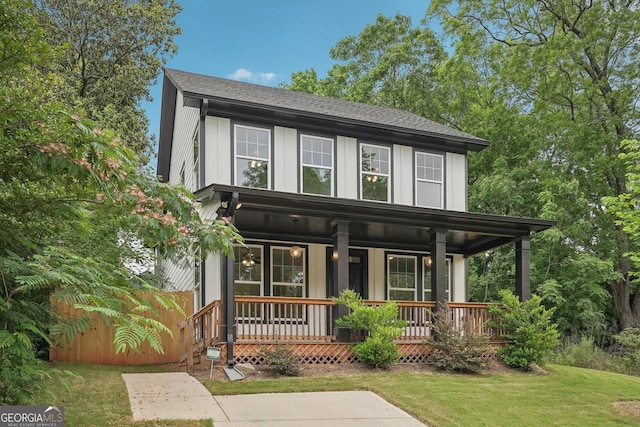 1158 Welch St SW, Atlanta, GA 30310 - view of front facade featuring board and batten siding, covered porch, a shingled roof, and a front lawn