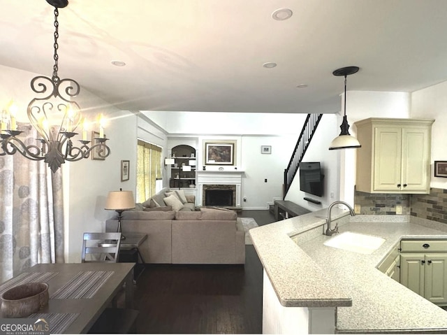 2674 Misty Rock Cv, Dacula, GA 30019 - kitchen featuring a sink, a peninsula, light countertops, and dark wood-style flooring