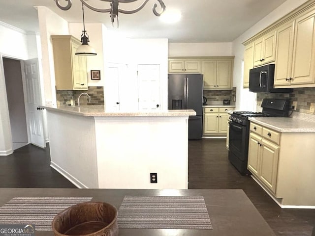 2674 Misty Rock Cv, Dacula, GA 30019 - kitchen with black appliances, cream cabinetry, tasteful backsplash, and a peninsula