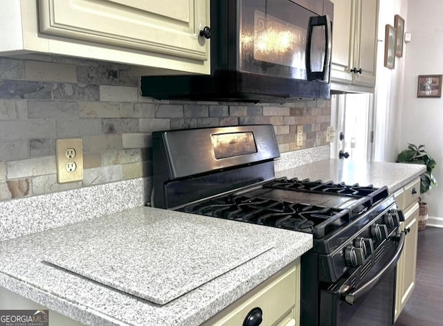 2674 Misty Rock Cv, Dacula, GA 30019 - kitchen with range with gas cooktop, light countertops, tasteful backsplash, and dark wood-type flooring