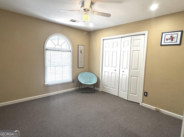 2674 Misty Rock Cv, Dacula, GA 30019 - sitting room featuring a ceiling fan, baseboards, and dark carpet