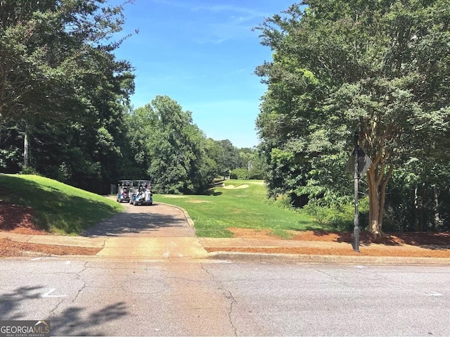 2674 Misty Rock Cv, Dacula, GA 30019 - view of asphalt street with curbs