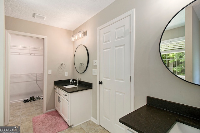 1478 Interlaken Pass, Jonesboro, GA 30238 - full bath with vanity, a textured ceiling, tile patterned floors, and a spacious closet