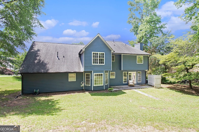 1478 Interlaken Pass, Jonesboro, GA 30238 - back of property featuring a chimney, a patio area, a yard, and roof with shingles