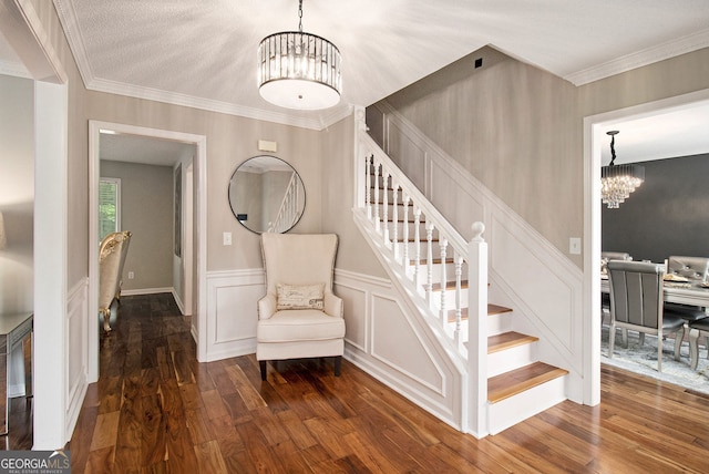 1478 Interlaken Pass, Jonesboro, GA 30238 - stairs featuring a chandelier, wood finished floors, crown molding, and a wainscoted wall