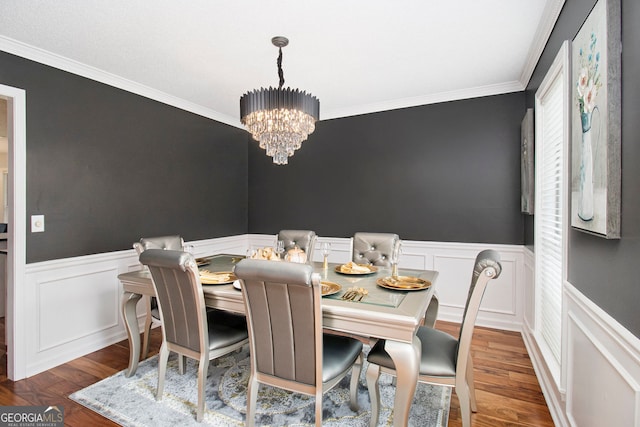 1478 Interlaken Pass, Jonesboro, GA 30238 - dining space featuring a chandelier, crown molding, wainscoting, wood finished floors, and a decorative wall