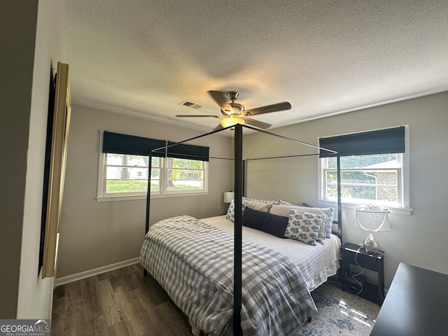 1815 Oak Spring St, Statham, GA 30666 - bedroom featuring a textured ceiling, dark wood-style flooring, and a ceiling fan