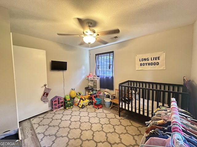 1815 Oak Spring St, Statham, GA 30666 - bedroom featuring a textured ceiling, a ceiling fan, and wood finished floors