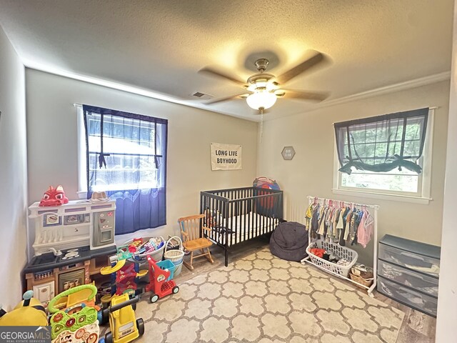 1815 Oak Spring St, Statham, GA 30666 - bedroom featuring a textured ceiling, a ceiling fan, a crib, and wood finished floors