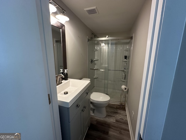 1815 Oak Spring St, Statham, GA 30666 - full bath featuring a stall shower, wood finished floors, toilet, vanity, and baseboards